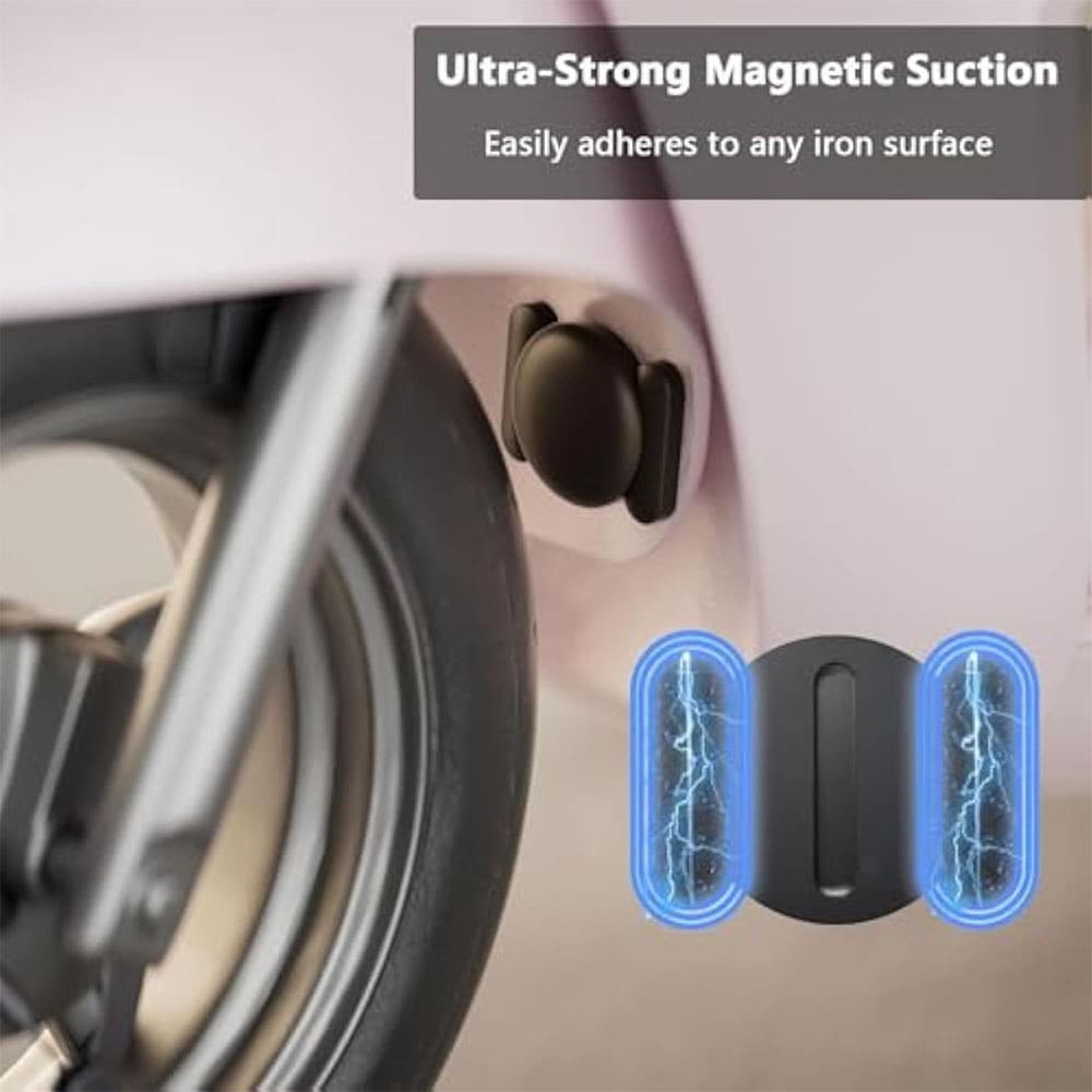 a black, magnetic car tracker (or similar GPS tracker) attached to the inside of the fender of a light-pink vehicle. The magnified inset at the bottom highlights the base of the tracker, showing two magnetic suction cups with a blue lightning effect to emphasize its "Ultra-Strong Magnetic Suction" feature