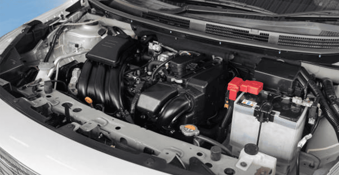 Open car engine bay showing the engine block, battery, air intake, and surrounding components