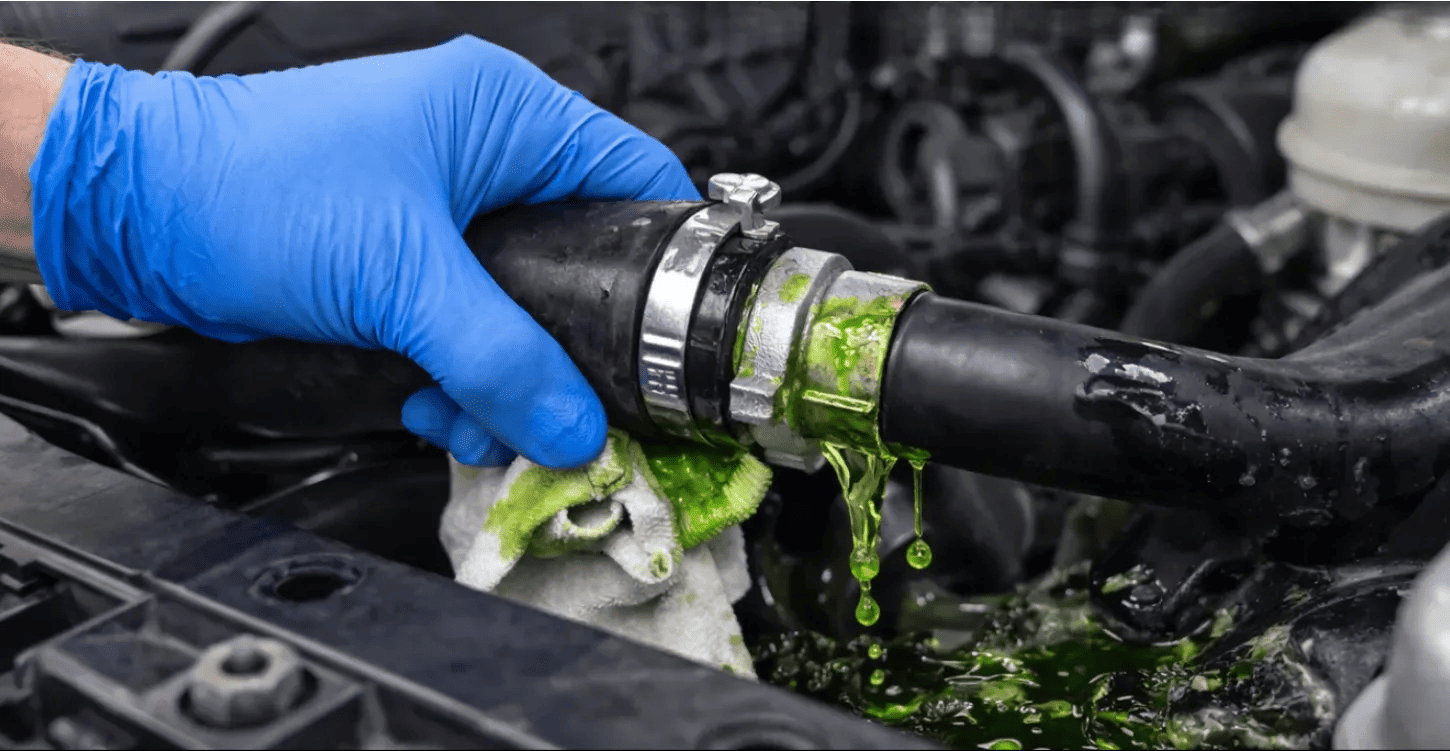Inspecting a leaking coolant hose connection to locate small coolant losses in a vehicle cooling system
