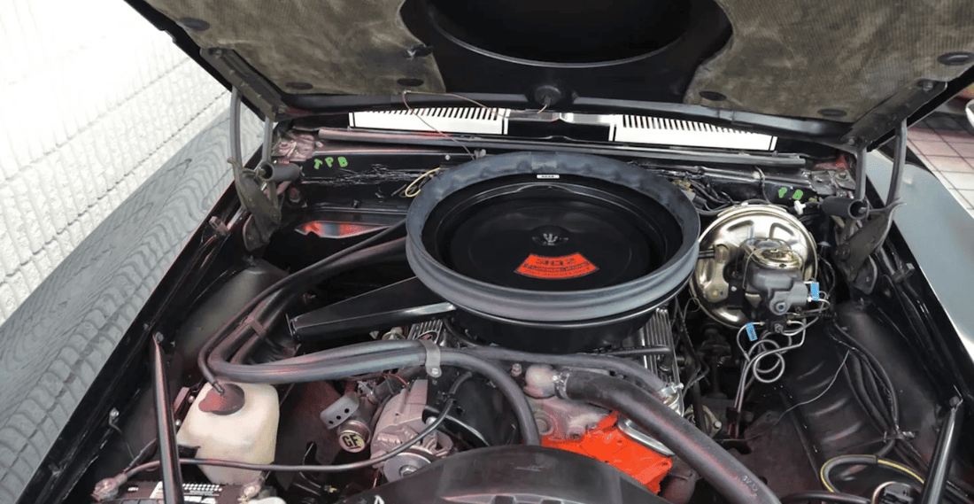 Car engine bay showing multiple cooling hoses and connections, highlighting the complexity of cooling system hose replacement